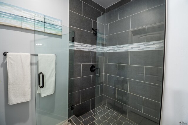 bathroom featuring a shower with door