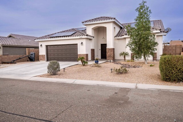 view of front of house featuring solar panels and a garage