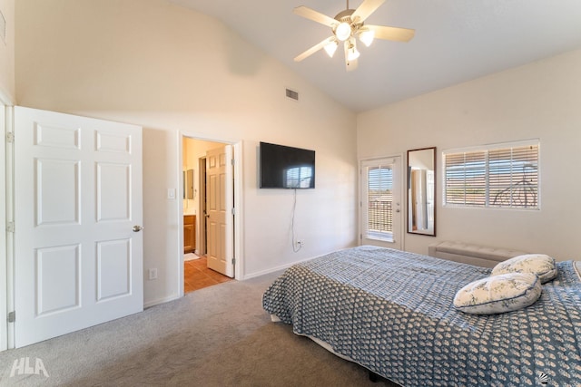 bedroom featuring lofted ceiling, ensuite bathroom, ceiling fan, and light colored carpet