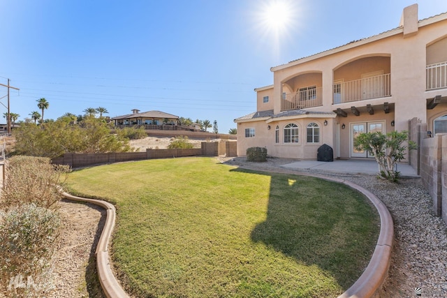 view of yard with a balcony and a patio