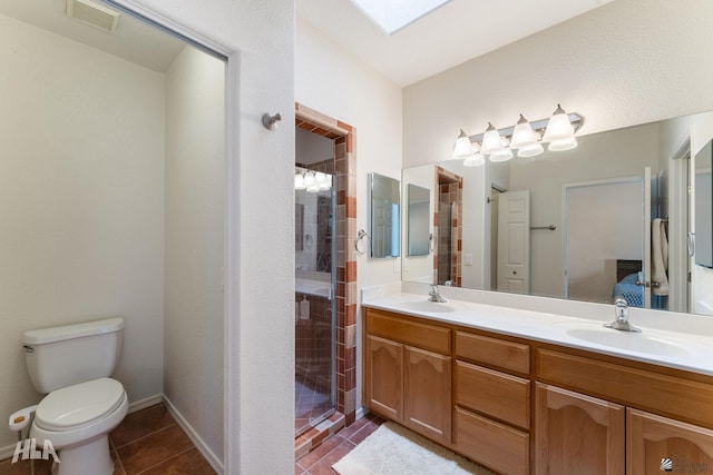 bathroom featuring toilet, tile patterned flooring, vanity, and walk in shower