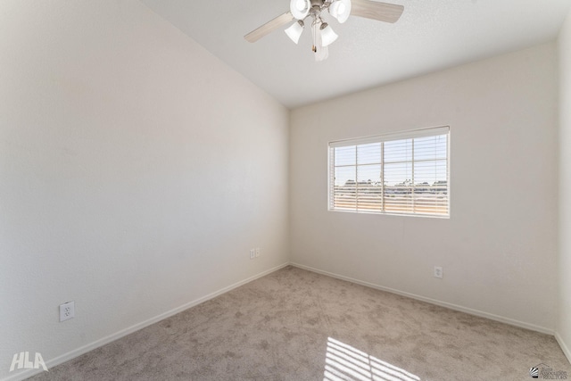 empty room with ceiling fan, light colored carpet, and lofted ceiling