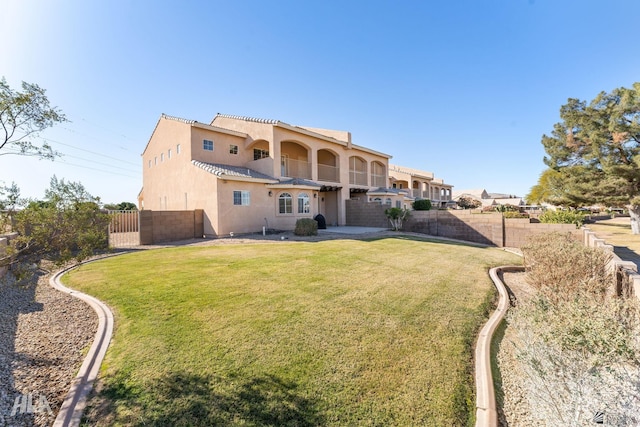 back of property featuring a lawn