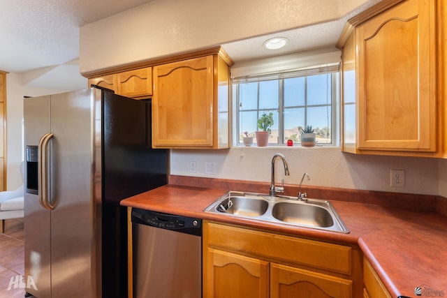 kitchen featuring sink, a textured ceiling, and appliances with stainless steel finishes