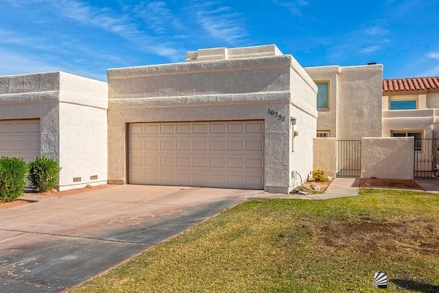 pueblo-style house with a garage