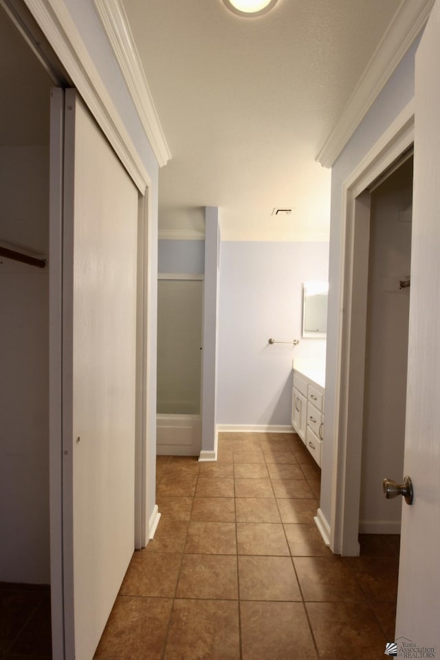 bathroom featuring vanity, tile patterned flooring, and crown molding