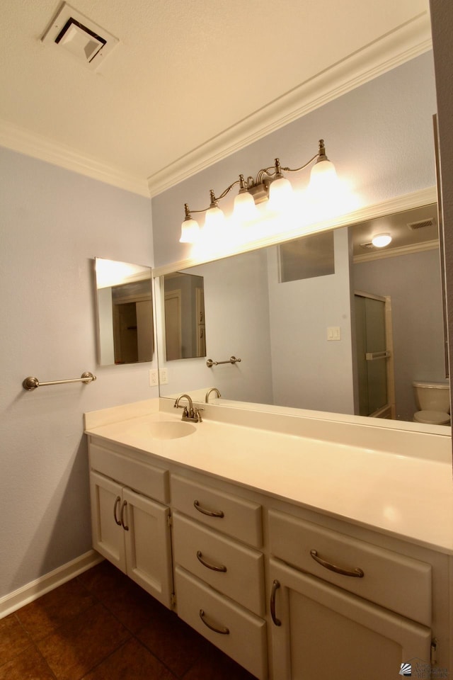 bathroom featuring crown molding, vanity, and toilet