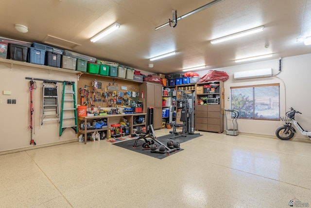 garage featuring a wall mounted air conditioner and a workshop area