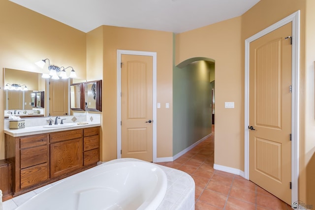 bathroom featuring vanity, tile patterned floors, and tiled bath