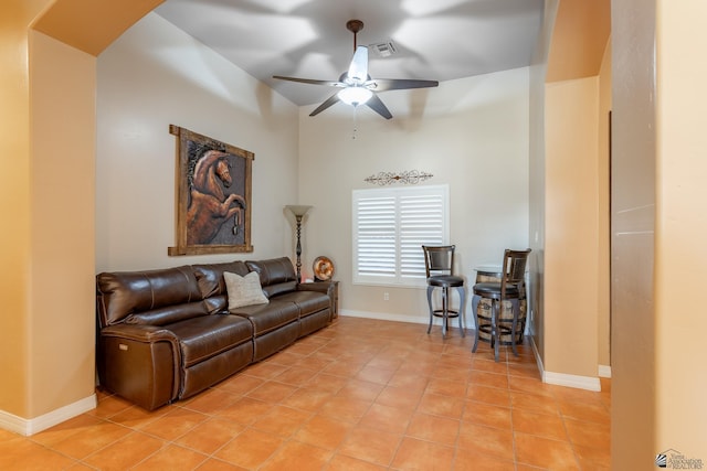 tiled living room featuring ceiling fan