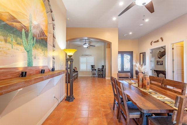 tiled dining space featuring ceiling fan