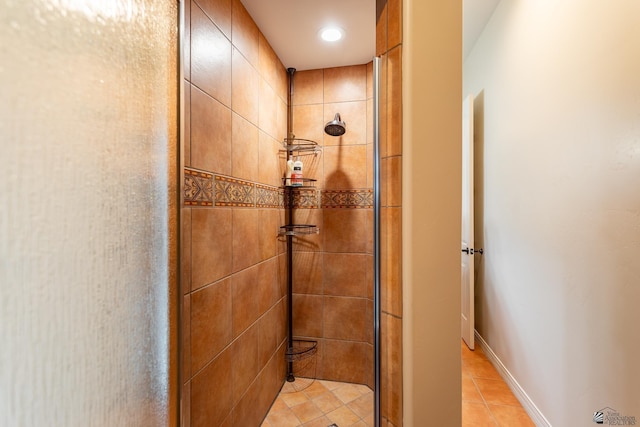 bathroom featuring tiled shower and tile patterned floors