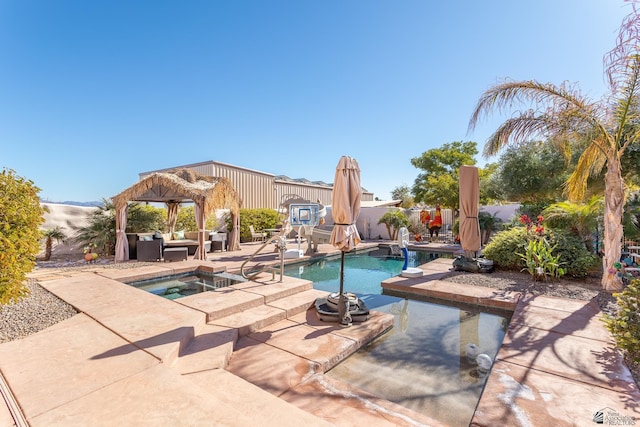 view of swimming pool with an in ground hot tub, an outdoor living space, and a patio area