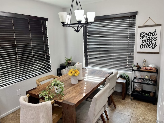 dining room featuring an inviting chandelier and light tile patterned floors