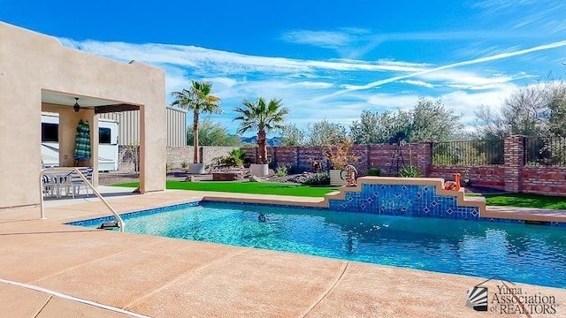 view of swimming pool with a patio, fence, and a fenced in pool