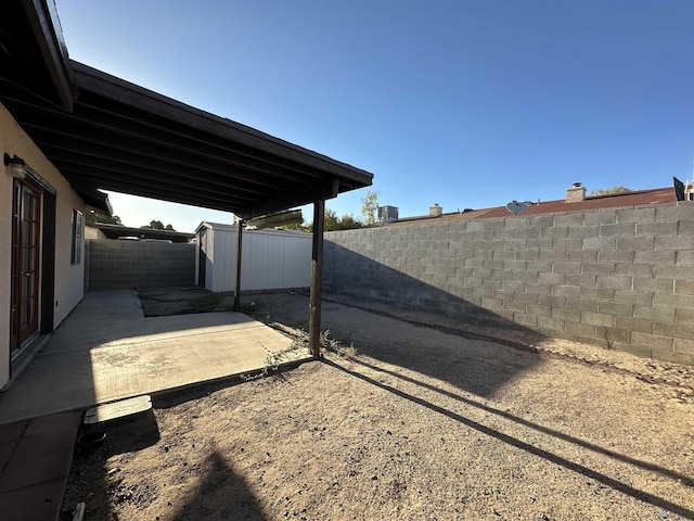 view of yard with a patio and a storage shed