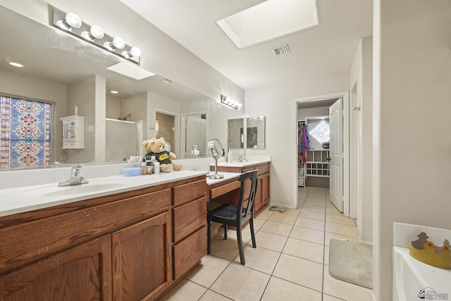 bathroom with vanity, an enclosed shower, tile patterned flooring, and a skylight