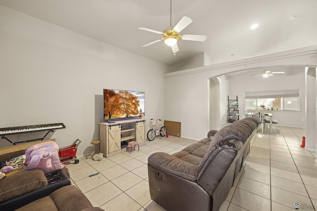 tiled living room with ceiling fan and lofted ceiling