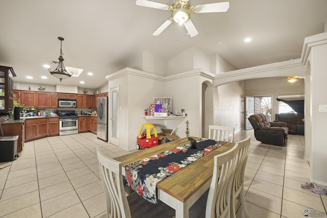 dining room featuring high vaulted ceiling, ceiling fan, and light tile patterned floors