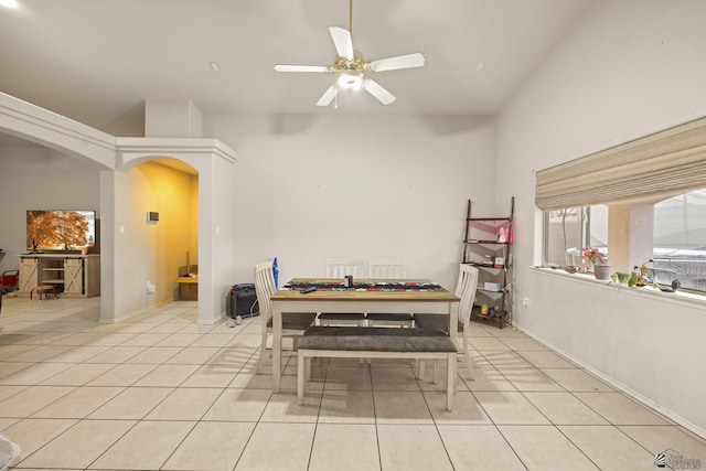 dining room with high vaulted ceiling, ceiling fan, and light tile patterned floors