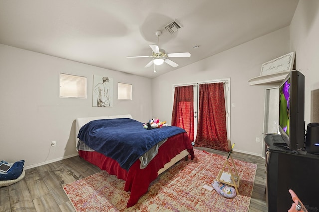 bedroom with lofted ceiling, hardwood / wood-style flooring, and ceiling fan