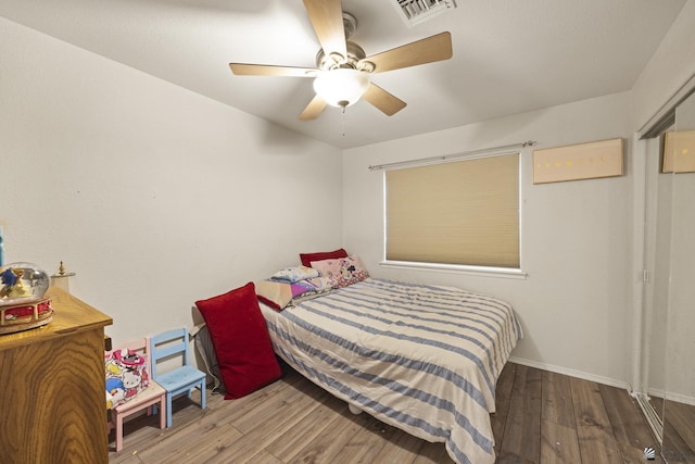 bedroom with wood-type flooring and ceiling fan