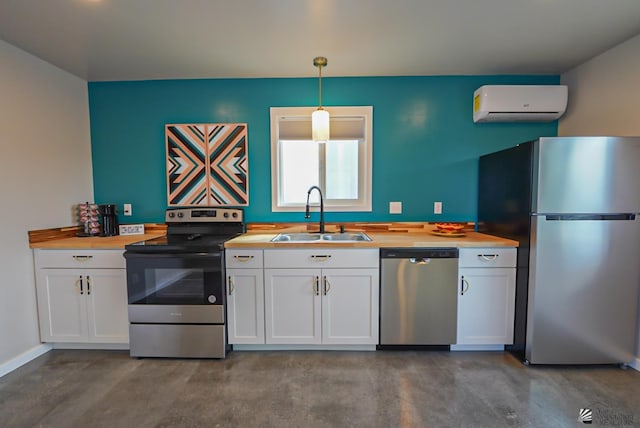 kitchen featuring a wall unit AC, a sink, finished concrete floors, stainless steel appliances, and white cabinetry