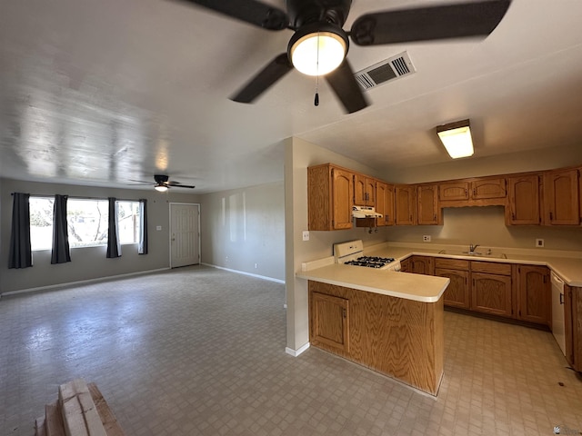 kitchen featuring visible vents, white appliances, light countertops, and a peninsula