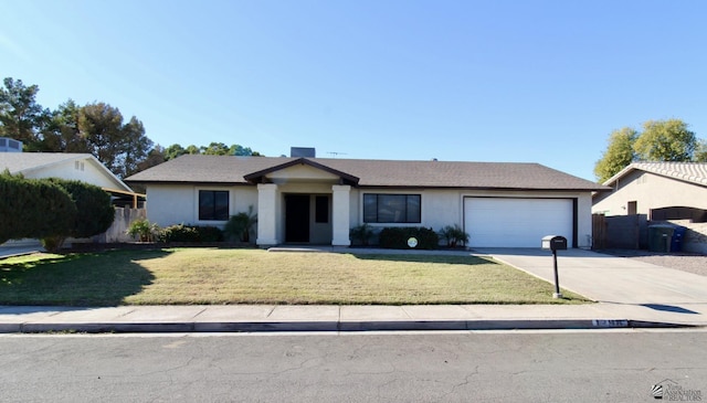 ranch-style house featuring a front lawn and a garage