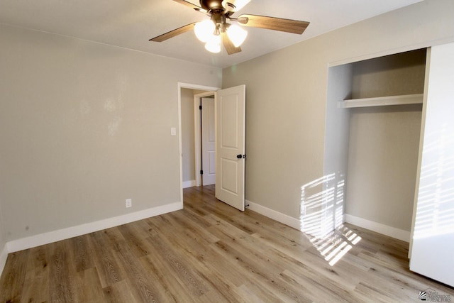 unfurnished bedroom featuring ceiling fan, light hardwood / wood-style floors, and a closet