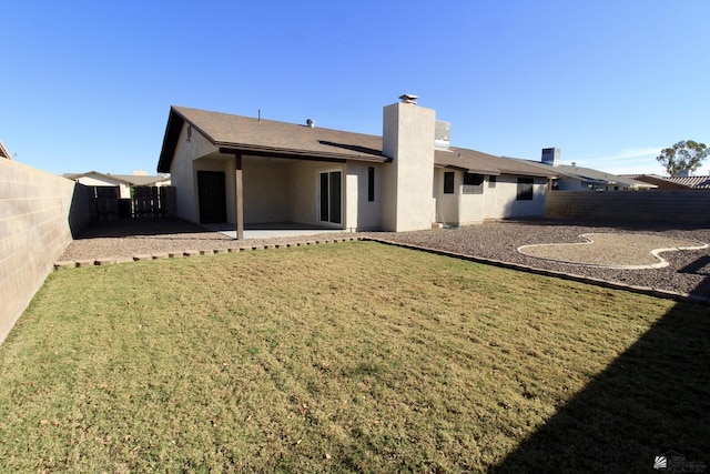 rear view of property with a patio area and a yard