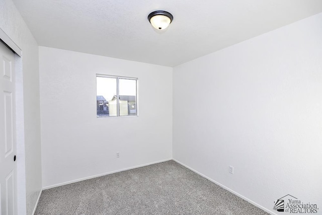 unfurnished bedroom featuring a closet, carpet flooring, and baseboards