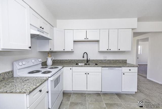 kitchen featuring white appliances, light stone counters, under cabinet range hood, white cabinetry, and a sink