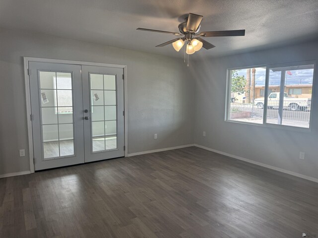 unfurnished room featuring dark wood-type flooring, a textured ceiling, french doors, baseboards, and ceiling fan