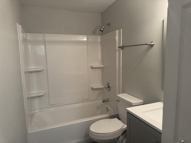 full bath with shower / bathing tub combination, toilet, vanity, and a textured wall