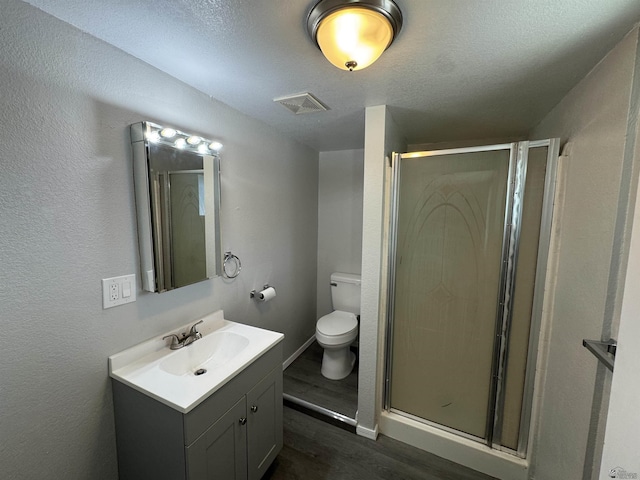 full bathroom featuring visible vents, toilet, a stall shower, and vanity