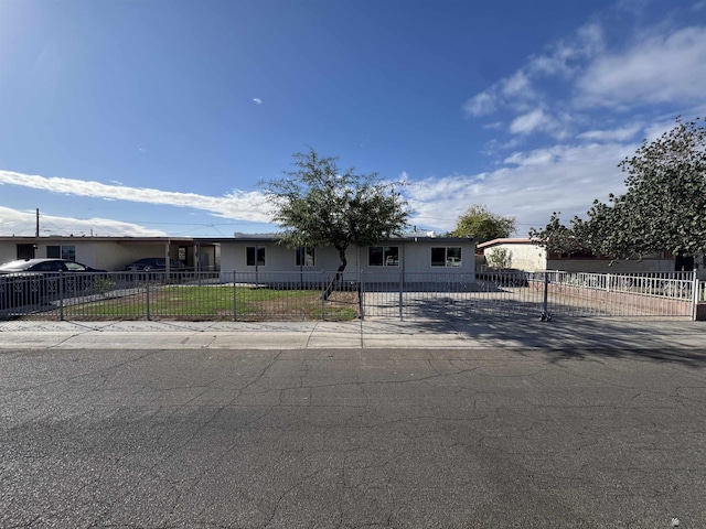 view of front of property featuring a fenced front yard and a front lawn