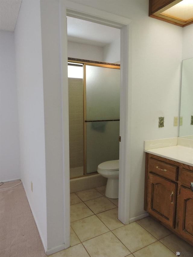 bathroom with walk in shower, tile patterned flooring, vanity, and toilet