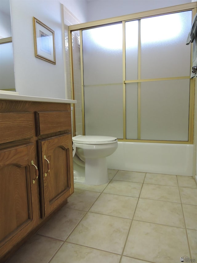 bathroom with shower / bath combination with glass door, tile patterned floors, and toilet