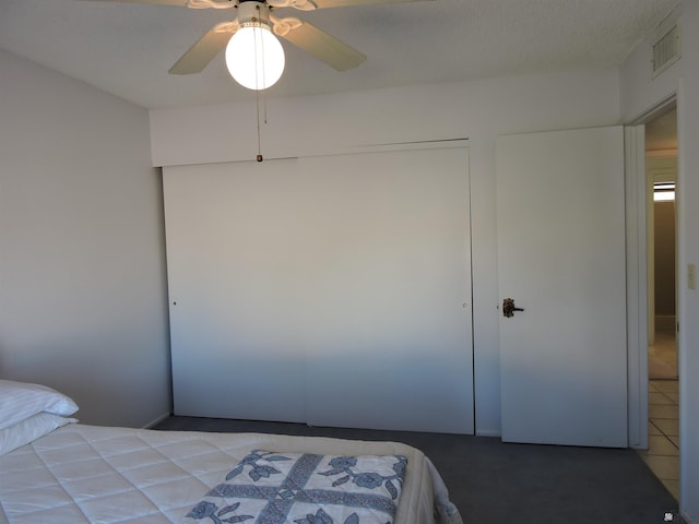 bedroom featuring ceiling fan and a closet