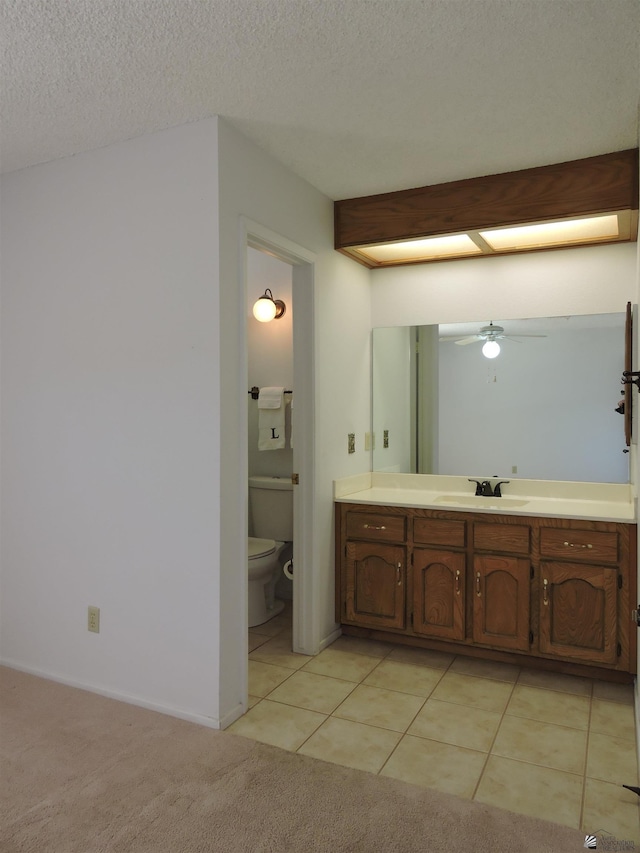 bathroom featuring toilet, a textured ceiling, tile patterned floors, ceiling fan, and vanity