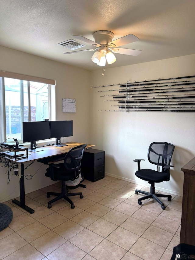 office area featuring a ceiling fan, visible vents, a textured ceiling, and light tile patterned floors