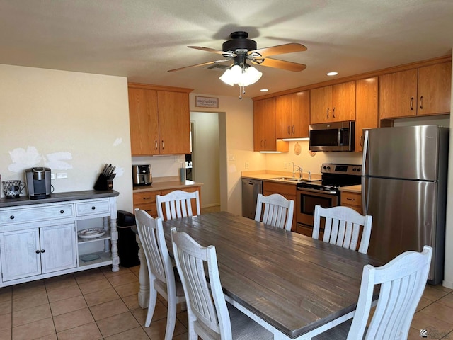 dining area with light tile patterned flooring, a ceiling fan, and recessed lighting