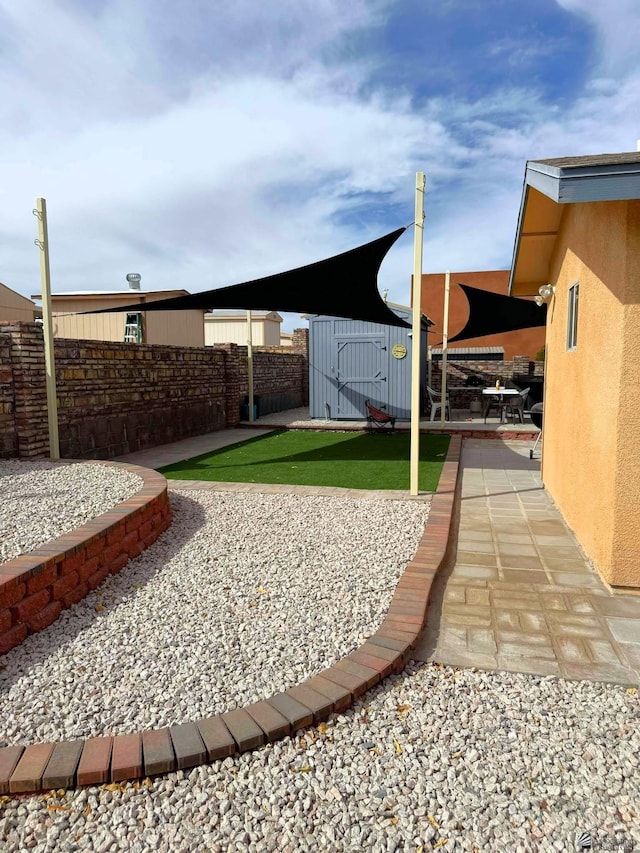 view of yard featuring fence and a patio