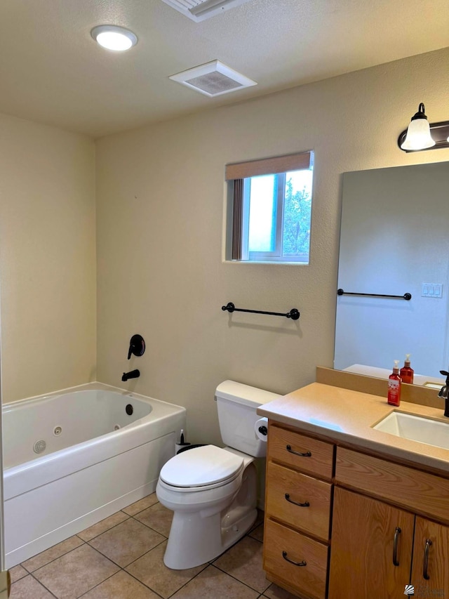 full bathroom with vanity, a tub with jets, tile patterned flooring, and toilet