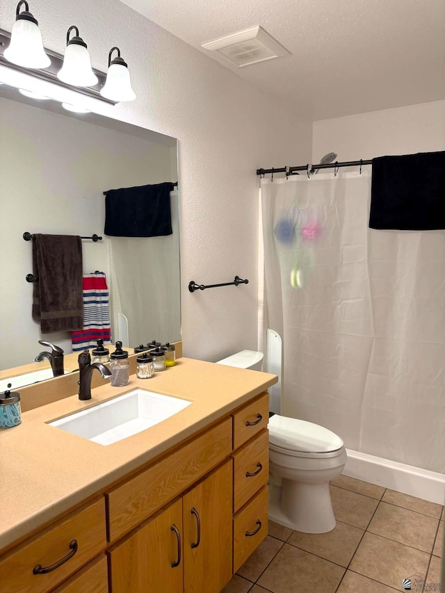 bathroom featuring visible vents, toilet, a shower with curtain, tile patterned floors, and vanity