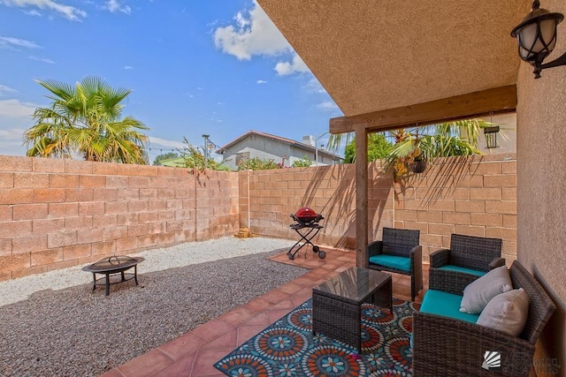 view of patio featuring a fire pit and a fenced backyard