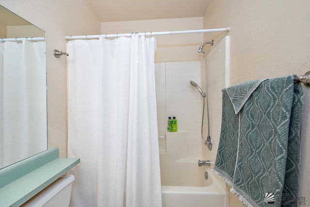 bathroom with toilet and shower / tub combo with curtain