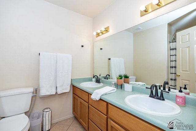 bathroom with a sink, visible vents, toilet, and tile patterned flooring