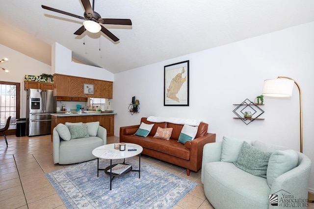 living area with light tile patterned floors, lofted ceiling, and a ceiling fan